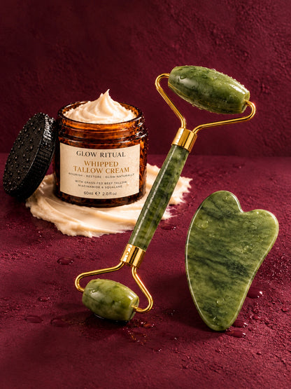 Glow Ritual Whipped Tallow Cream with the jade roller and gua sha on deep berry