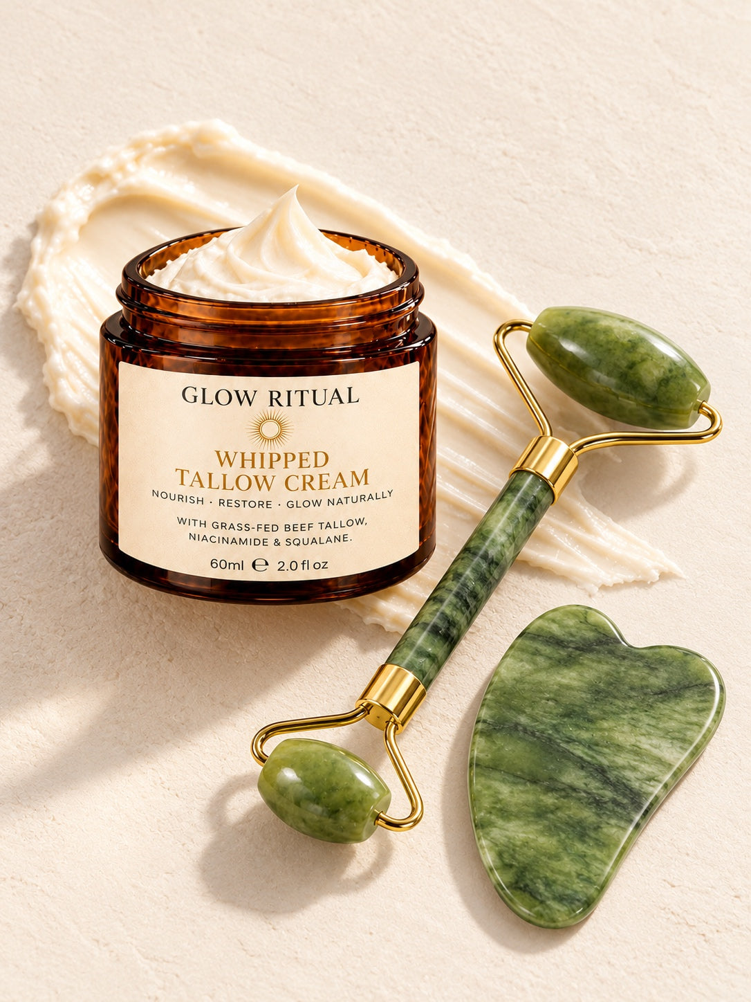 Glow Ritual Whipped Tallow Cream with the jade roller and gua sha on a swipe of cream